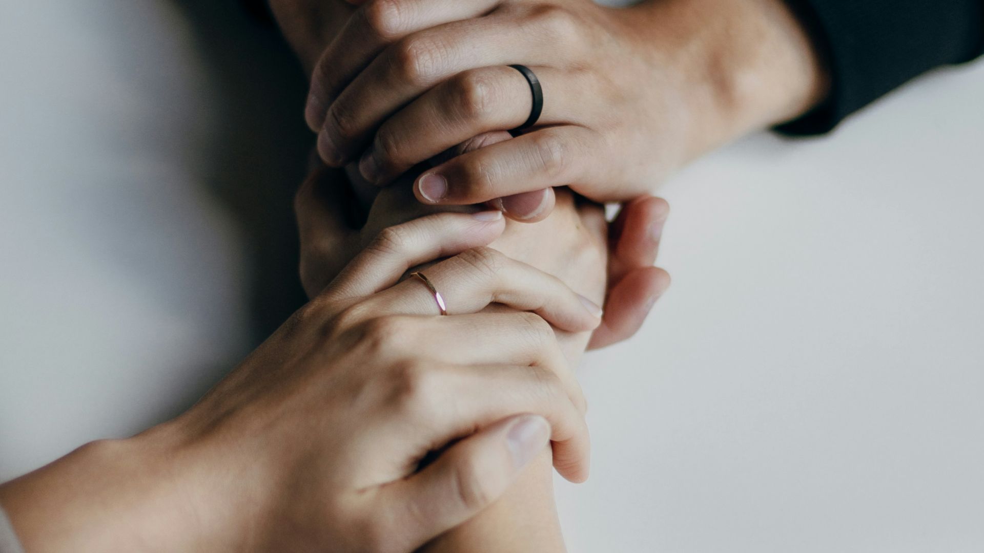 person in black long sleeve shirt holding babys feet