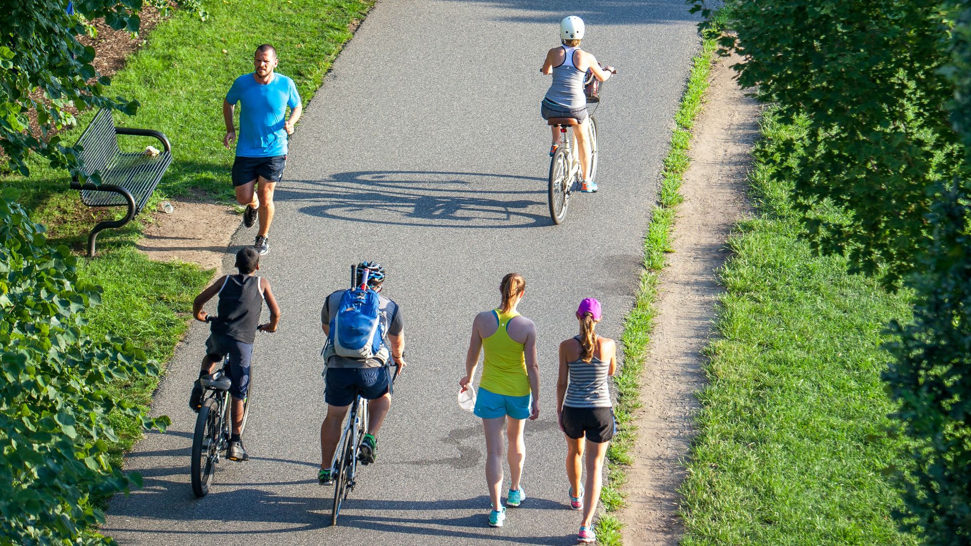 people riding bicycle on road during daytime