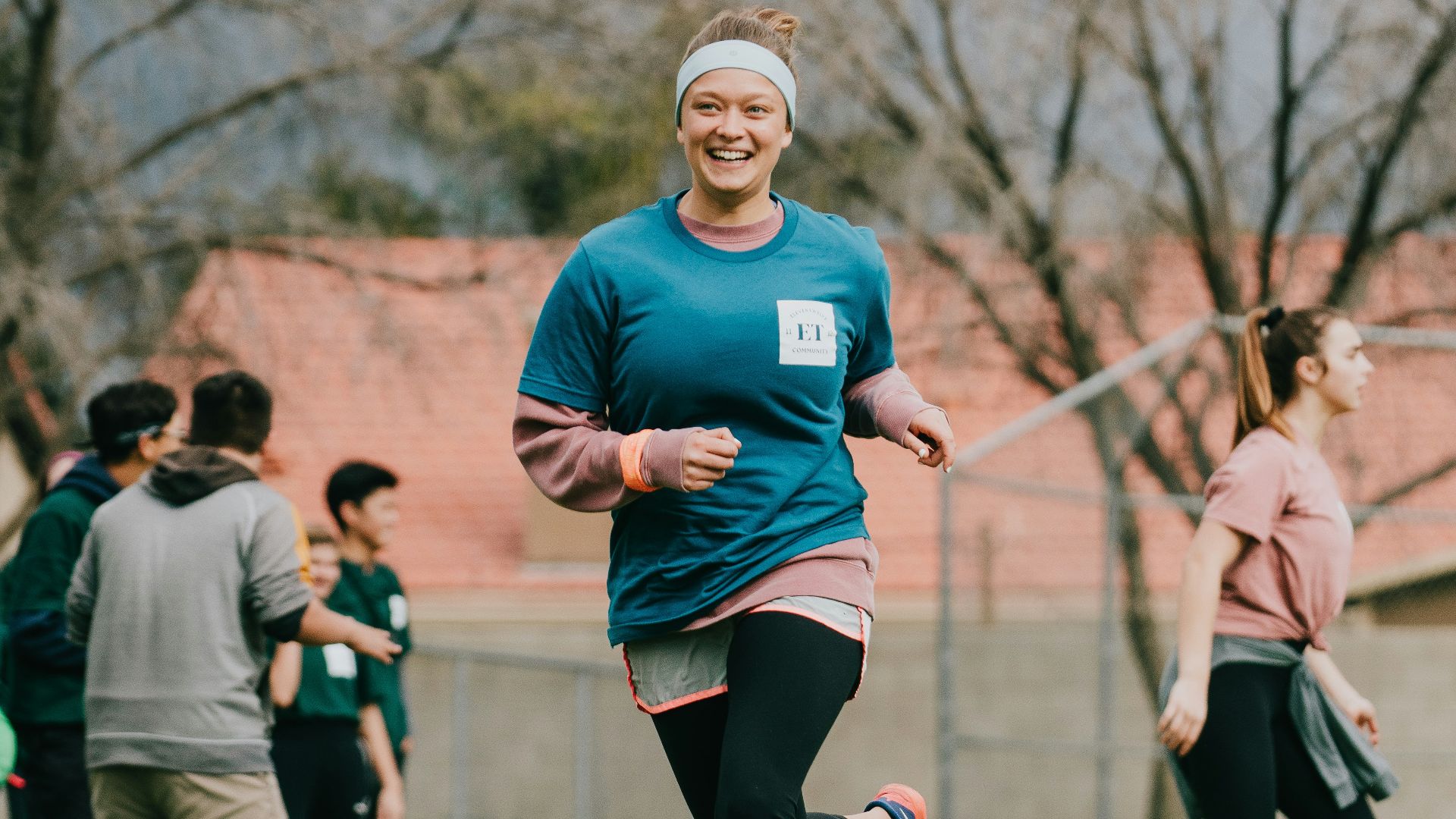 selective focus photography of woman running on green lawn grass during dytime