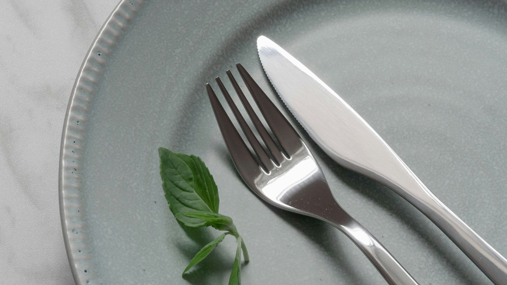 silver fork on blue round plate