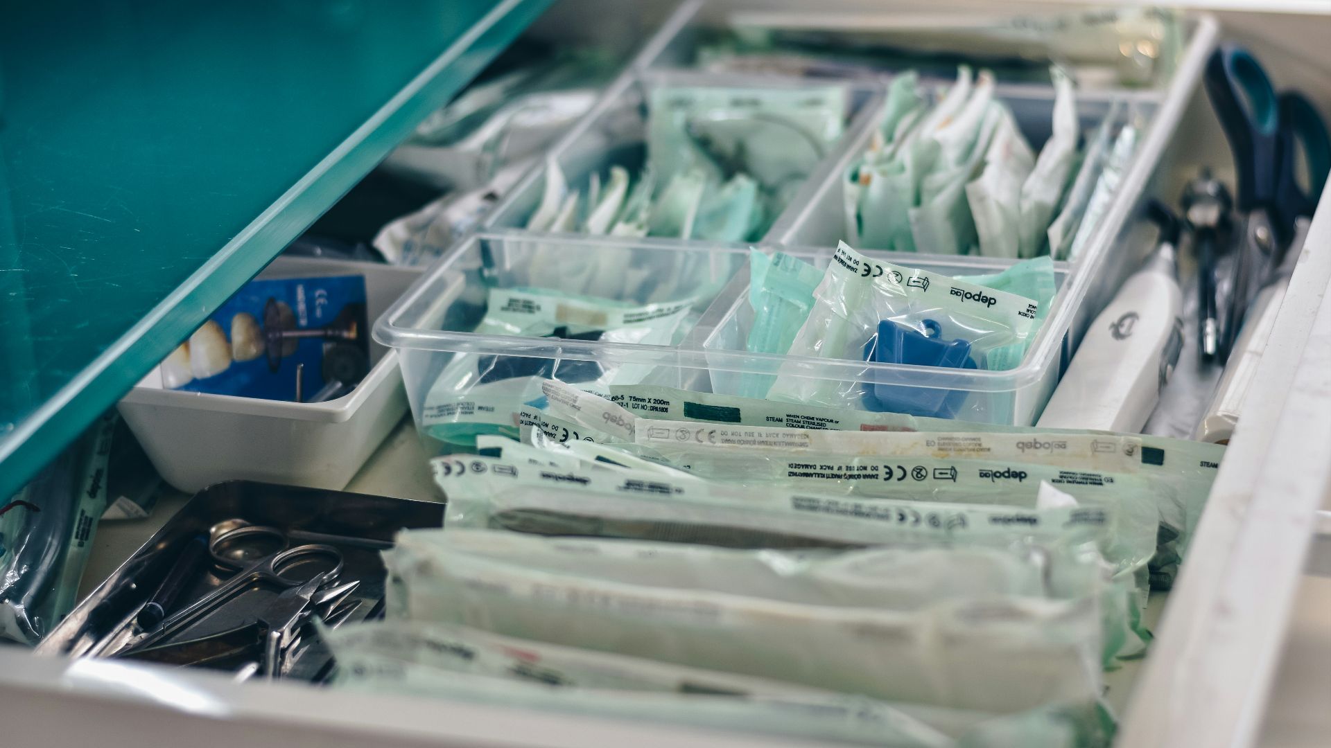 white packs with scissors and medicine on gray tray