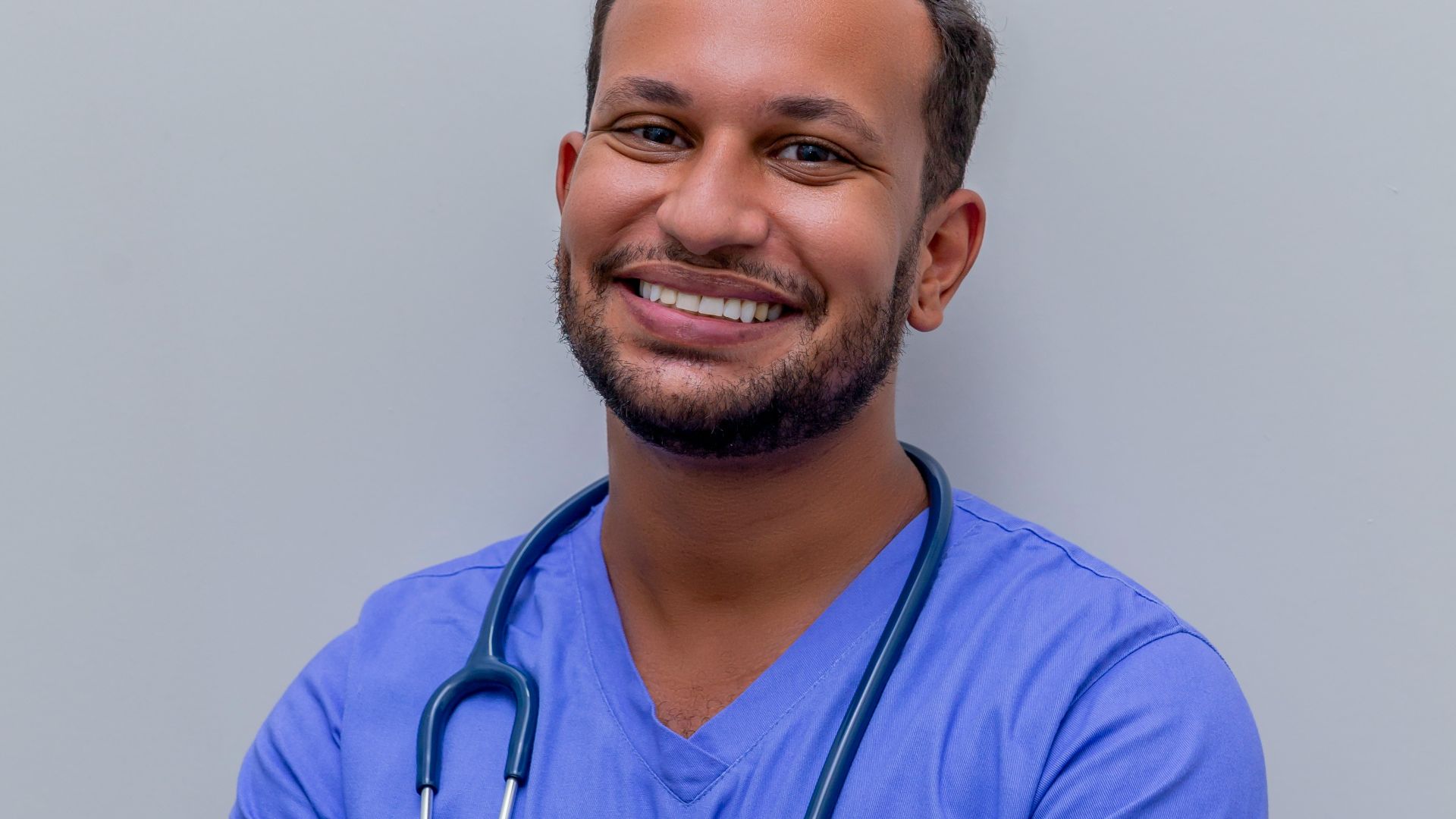 man in blue crew neck t-shirt smiling
