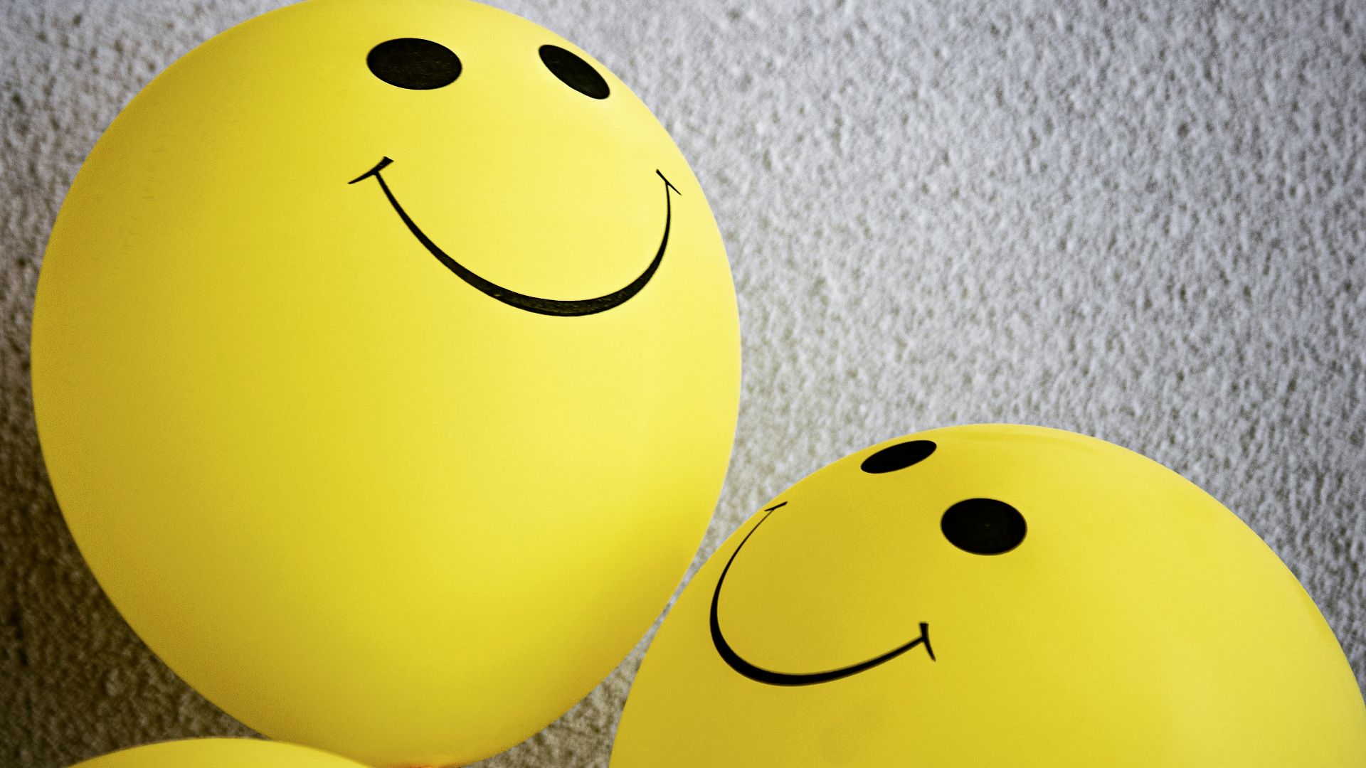 yellow smiley emoji on gray textile