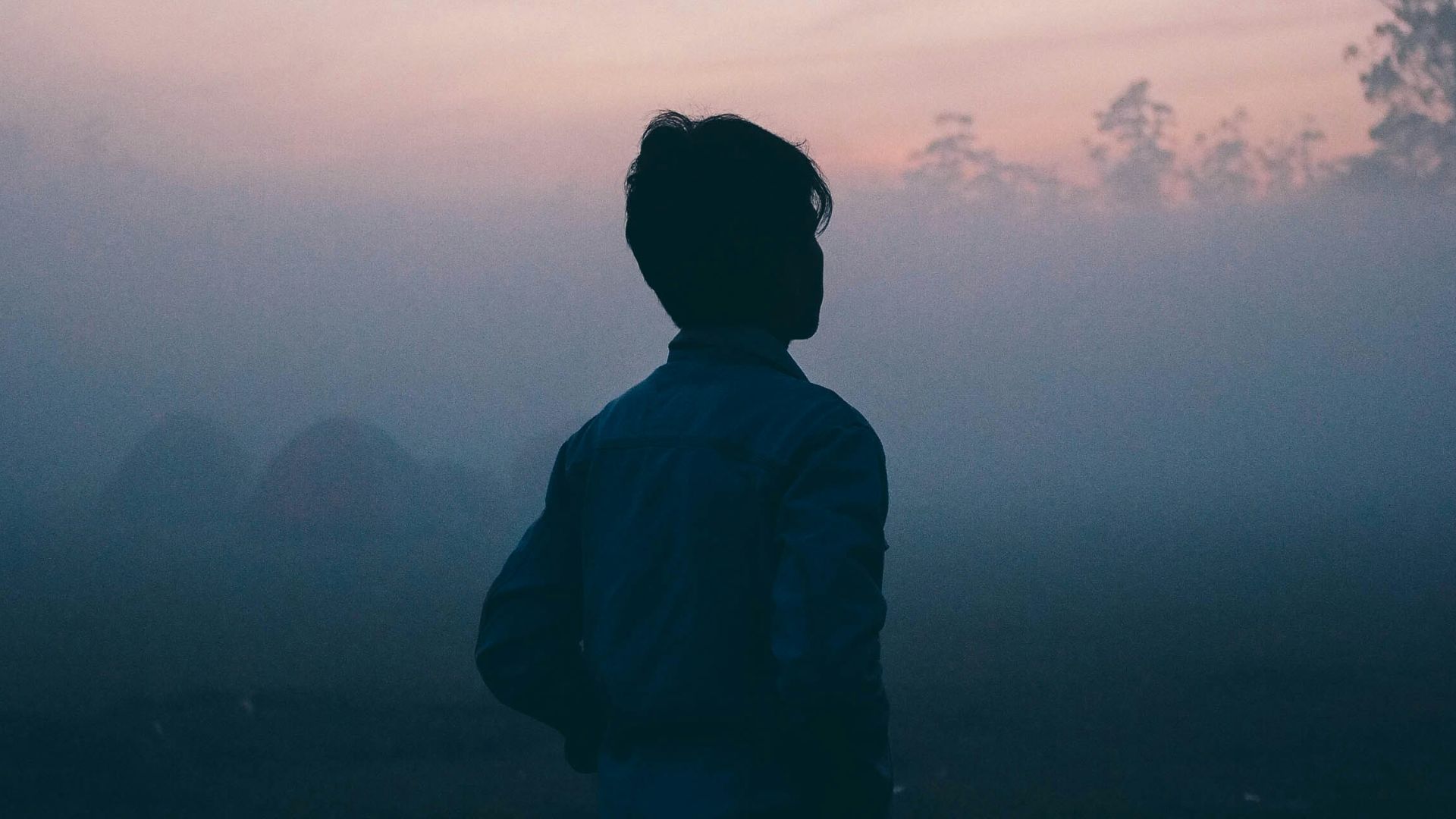 a man walks alone in the haze