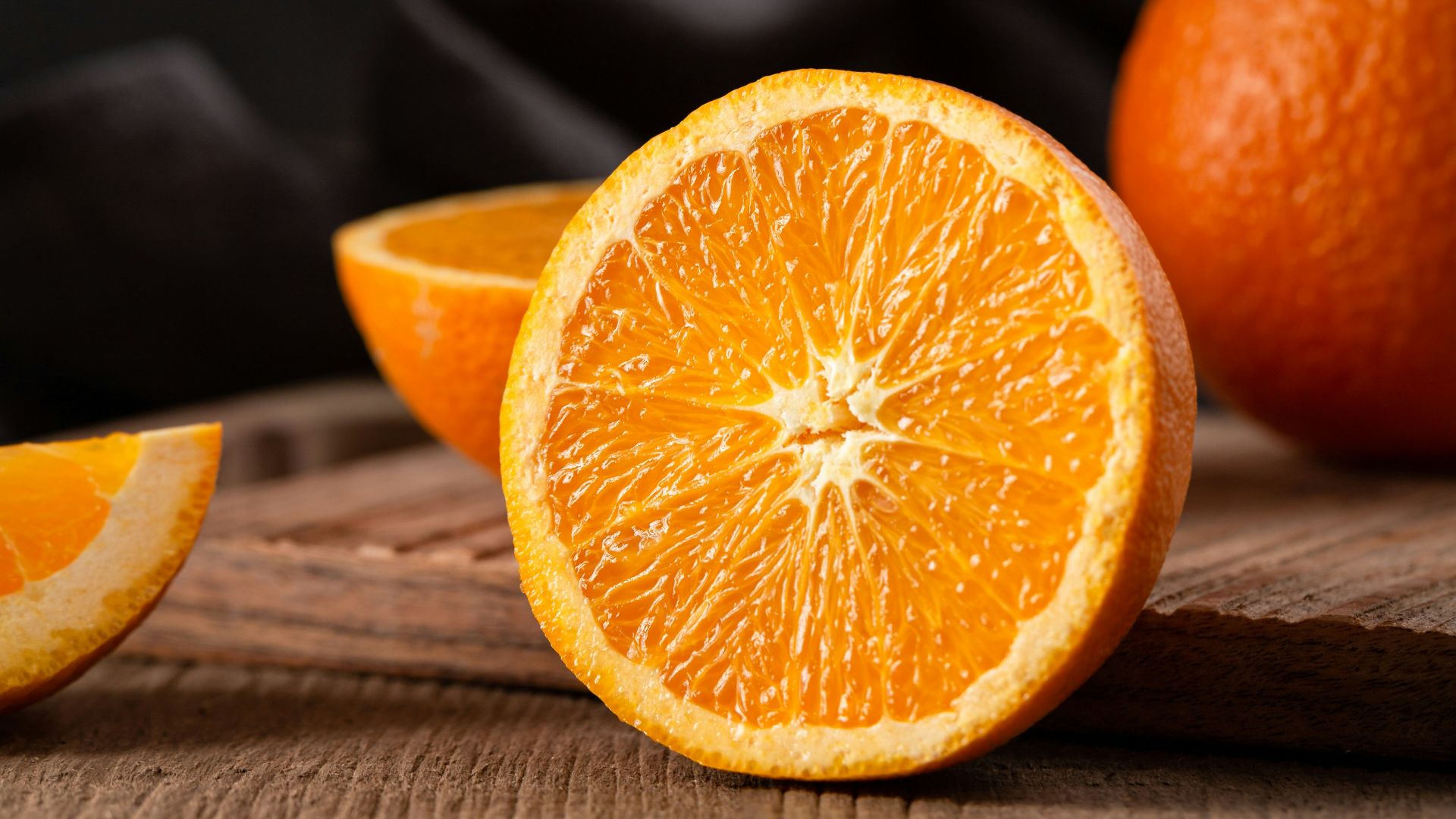 sliced orange fruit on brown wooden table