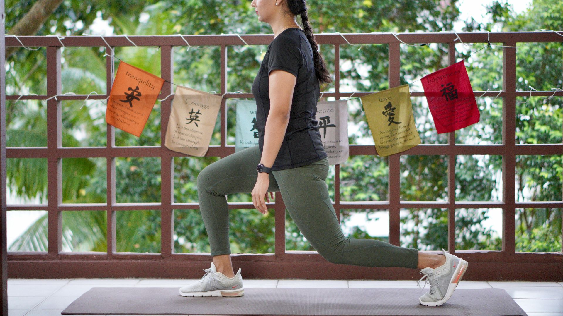 a woman in a black shirt is doing yoga