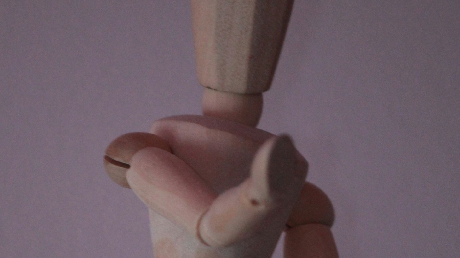 brown wooden human figure on white surface