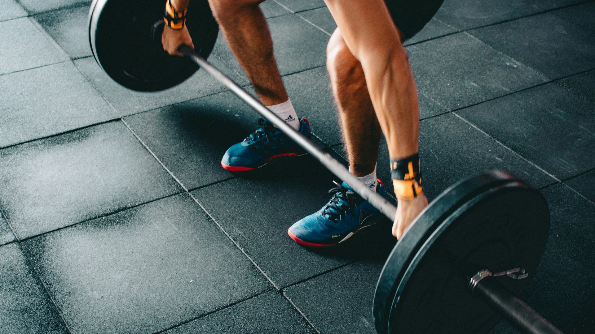 person holding black barbell