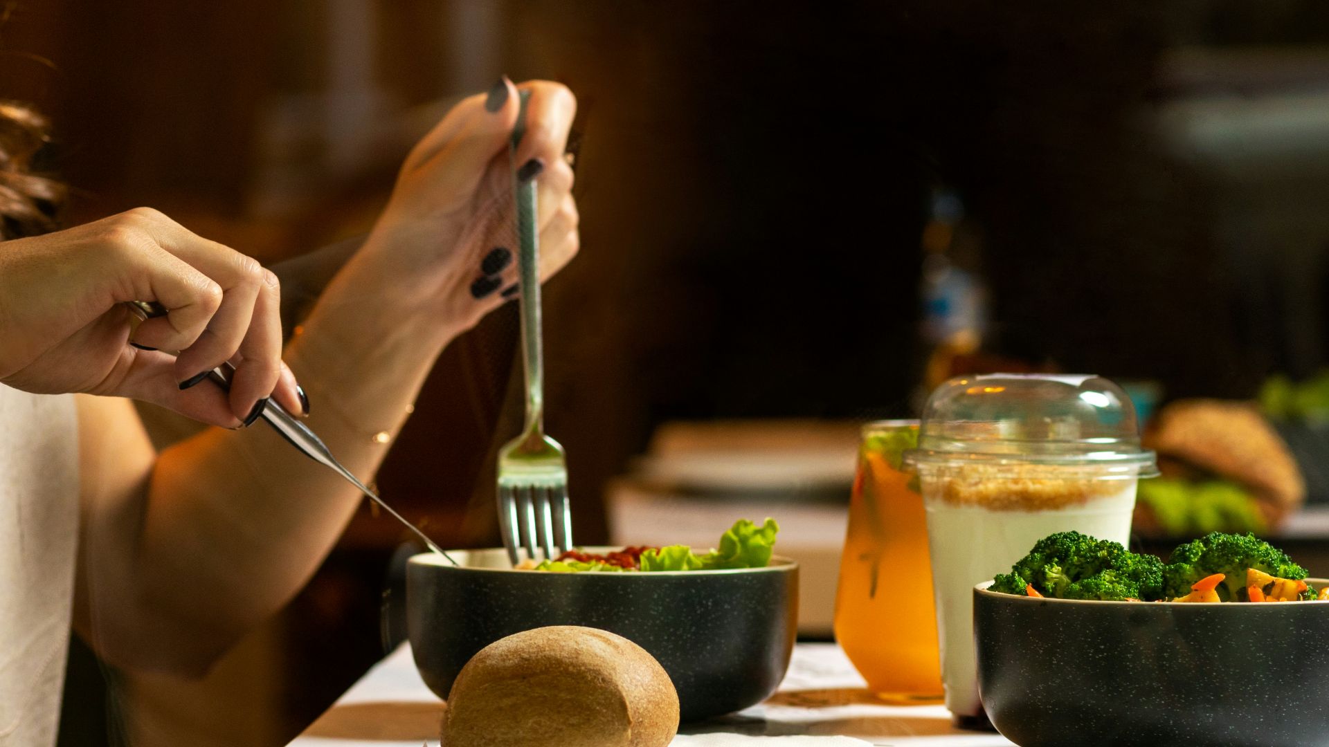 person holding silver fork and knife