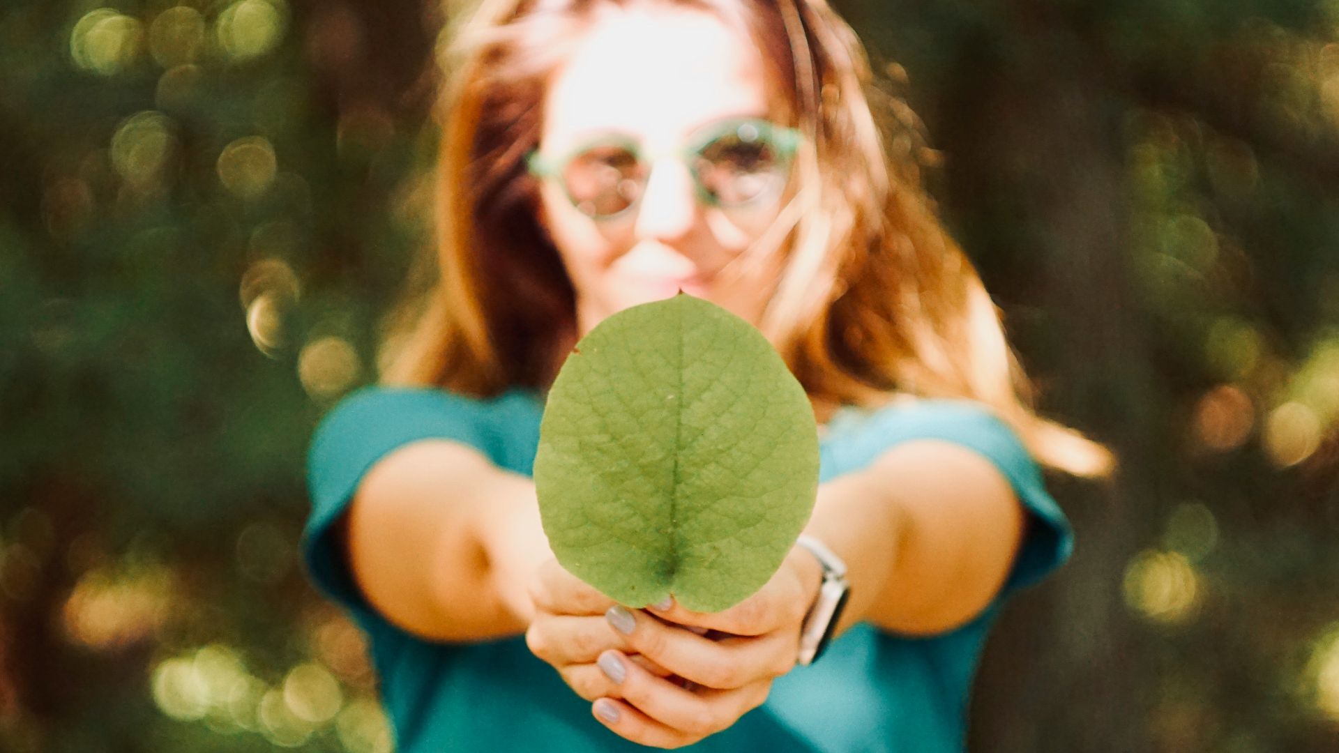 woman holding leaf