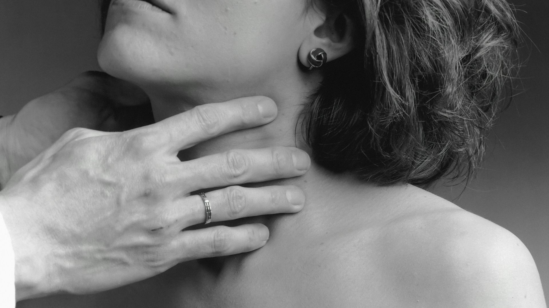 a woman has her hand on the shoulder of a man