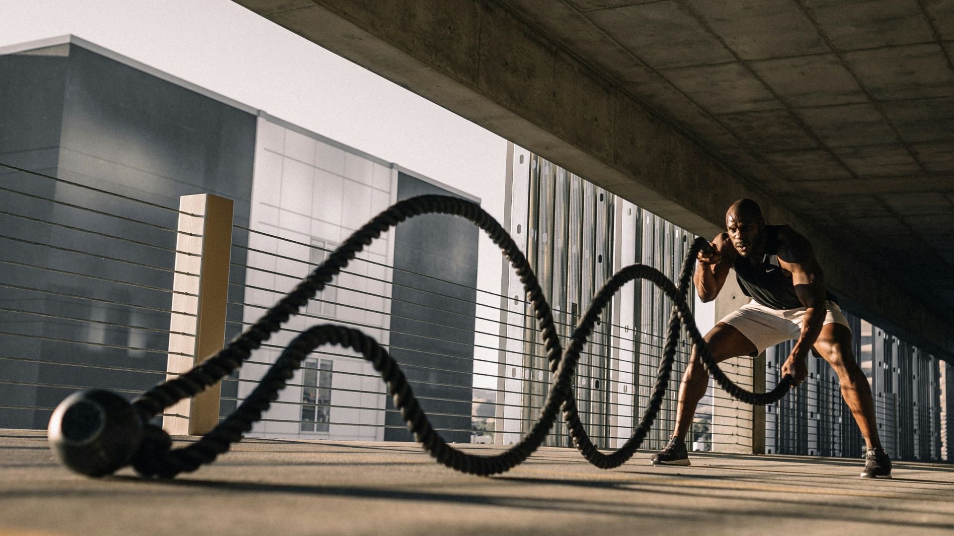 woman in black tank top sitting on brown wooden bench