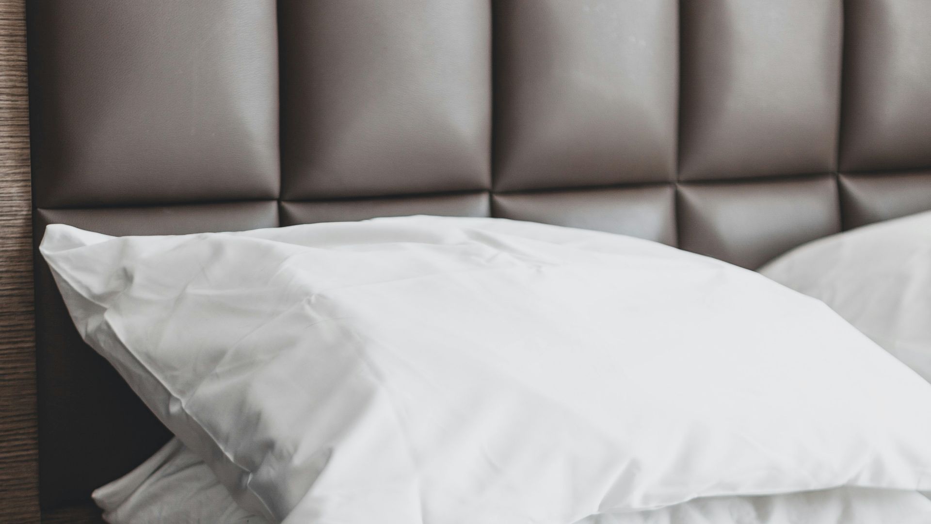 white bed pillow on bed