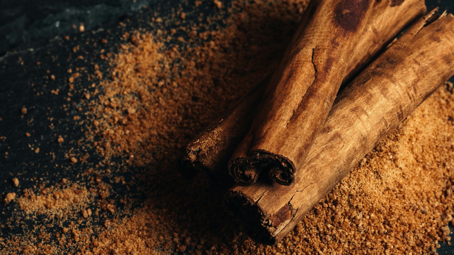 a bowl of nuts and cinnamon sticks on a table