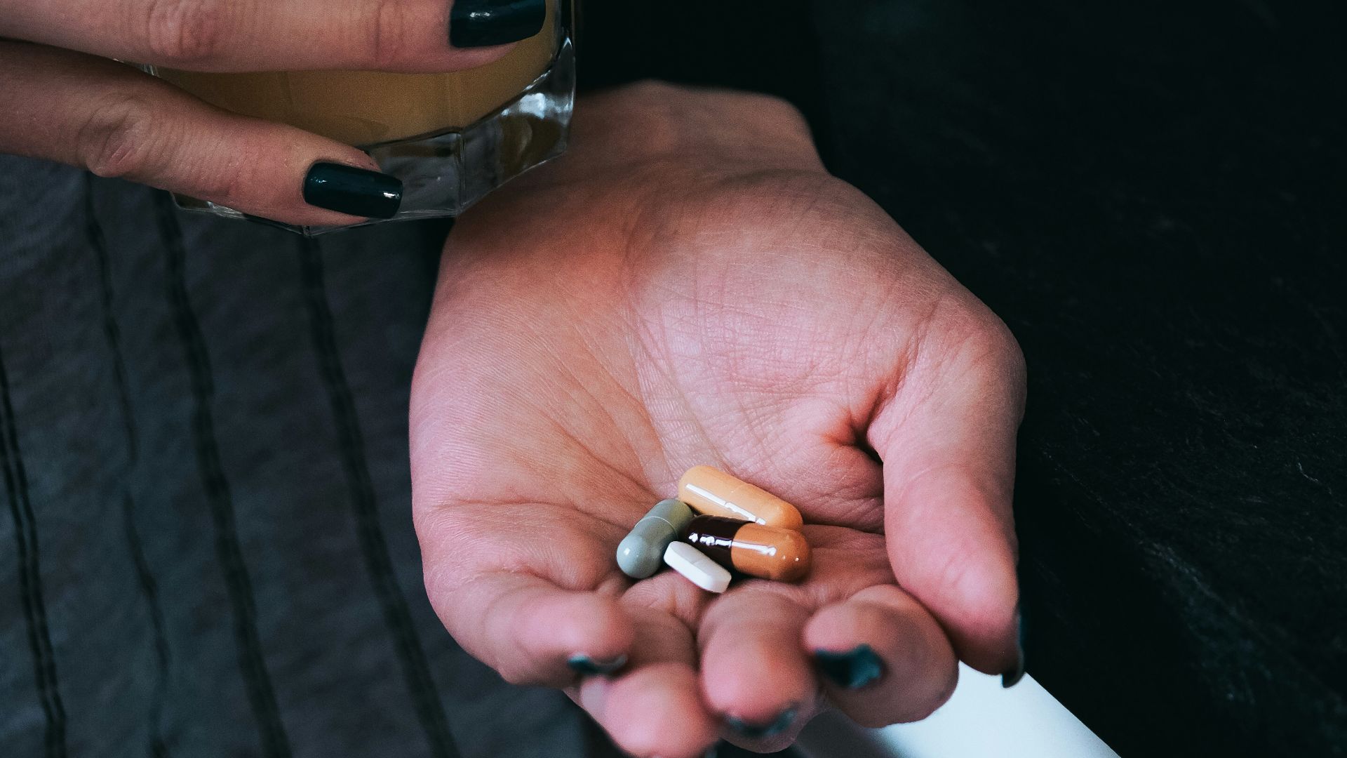 a person holding a glass of beer