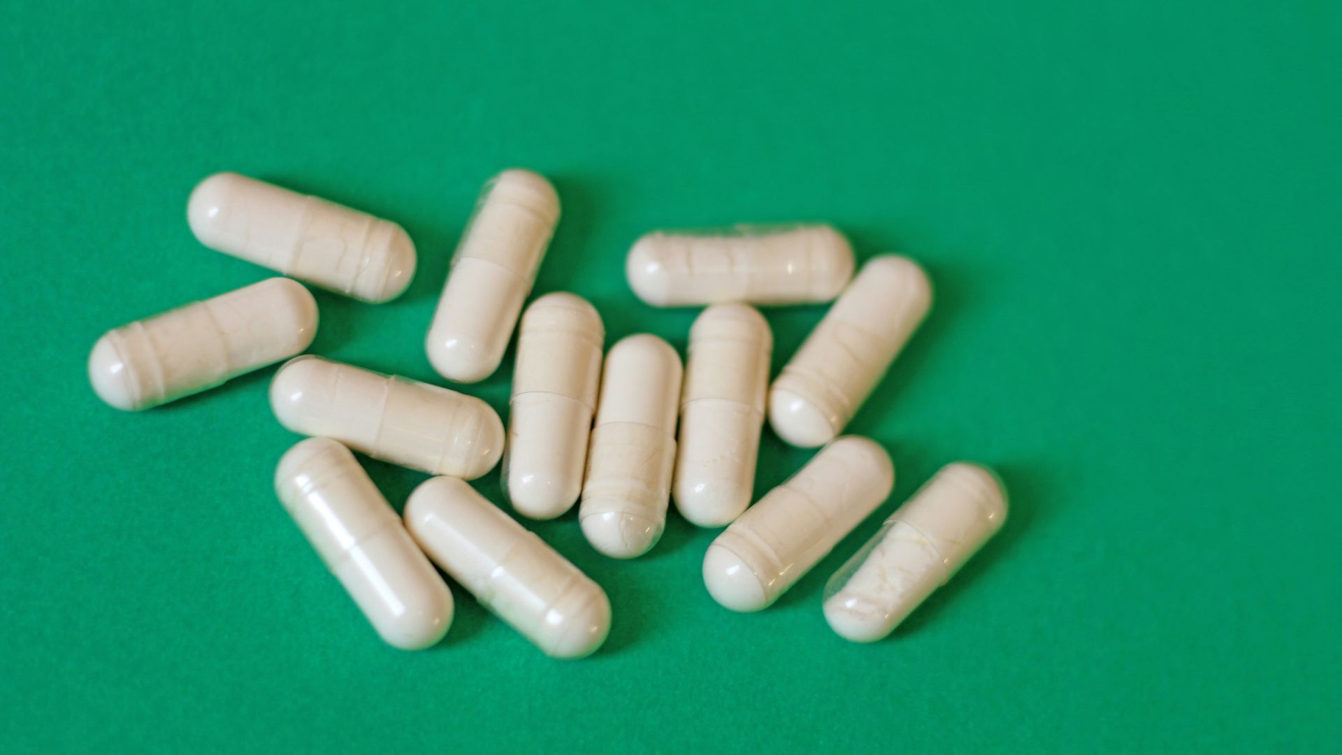 A pile of pills sitting on top of a green table