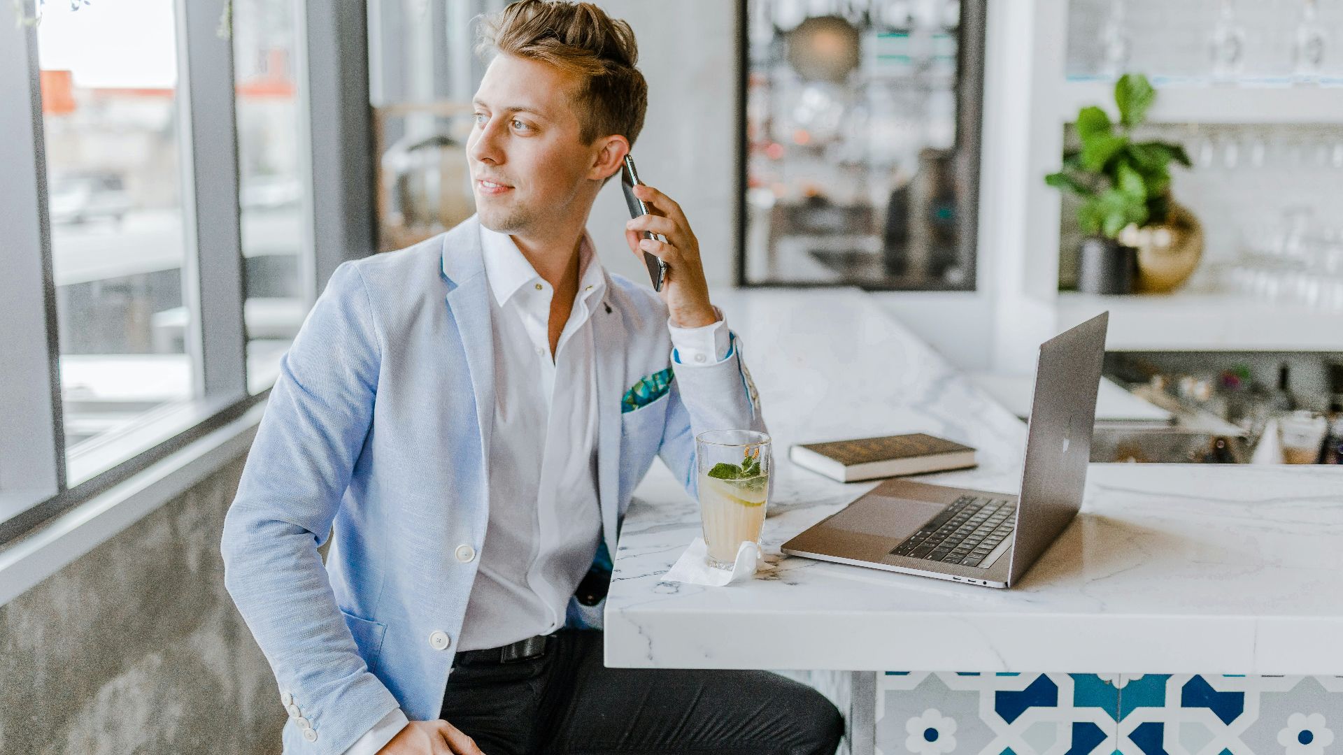 man sitting beside white wooden table