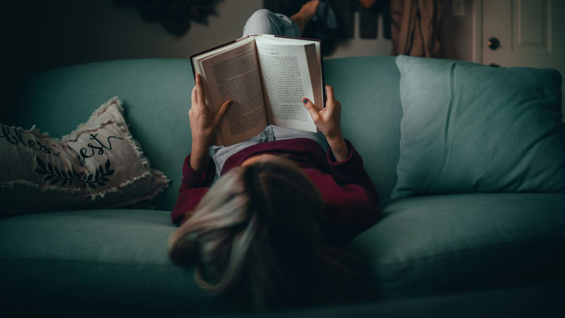 woman in red shirt reading book
