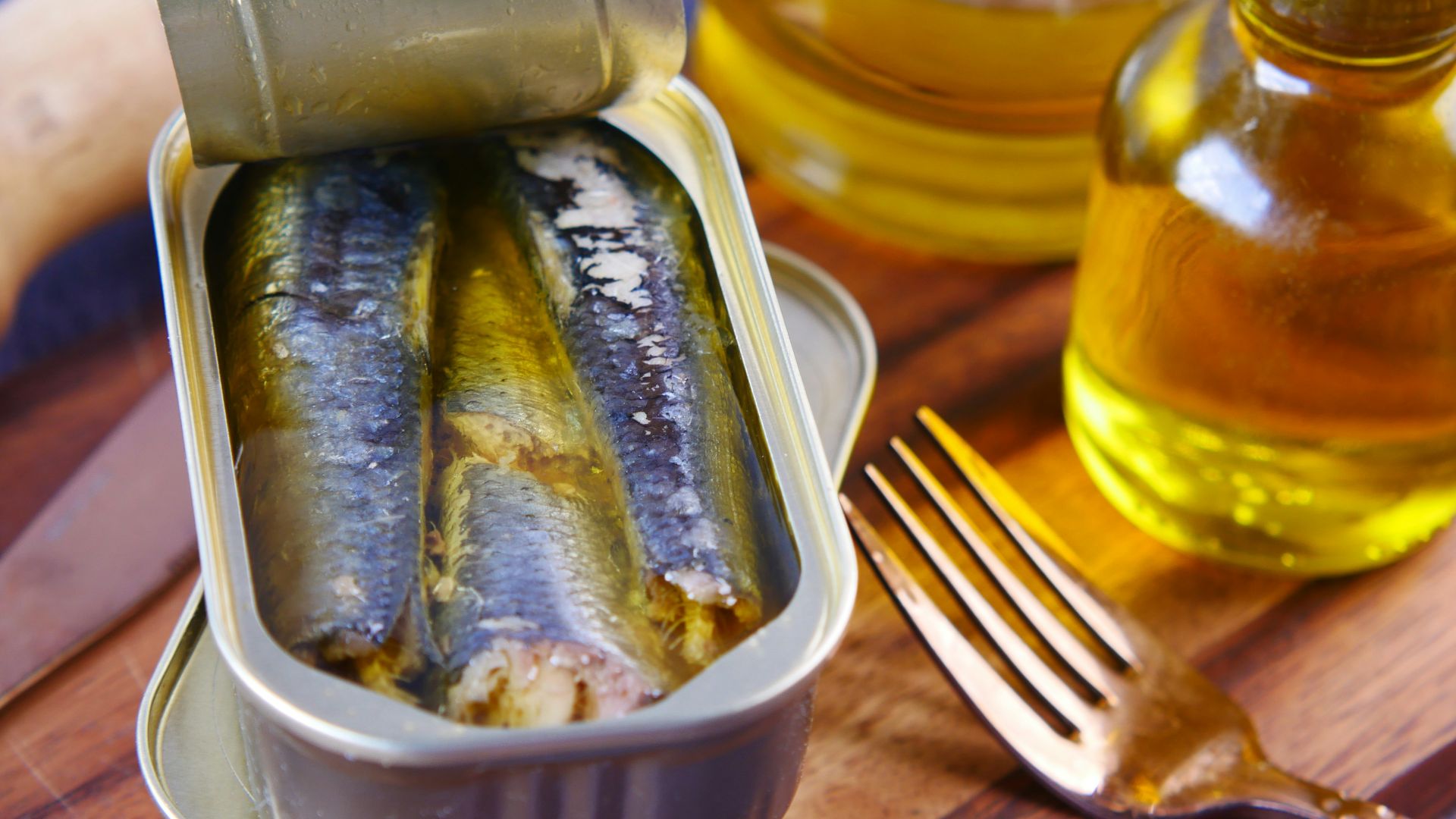 a tin of sardines sitting on top of a wooden table