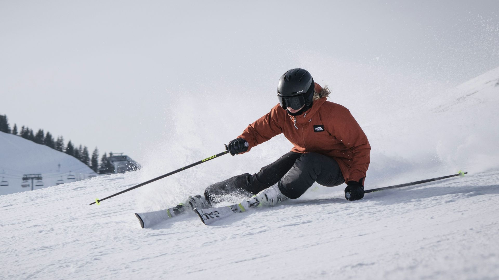 person in red jacket and black pants riding on snow board during daytime
