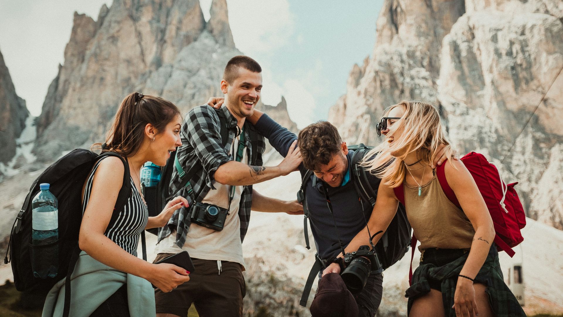 low-angle photography of two men playing beside two women