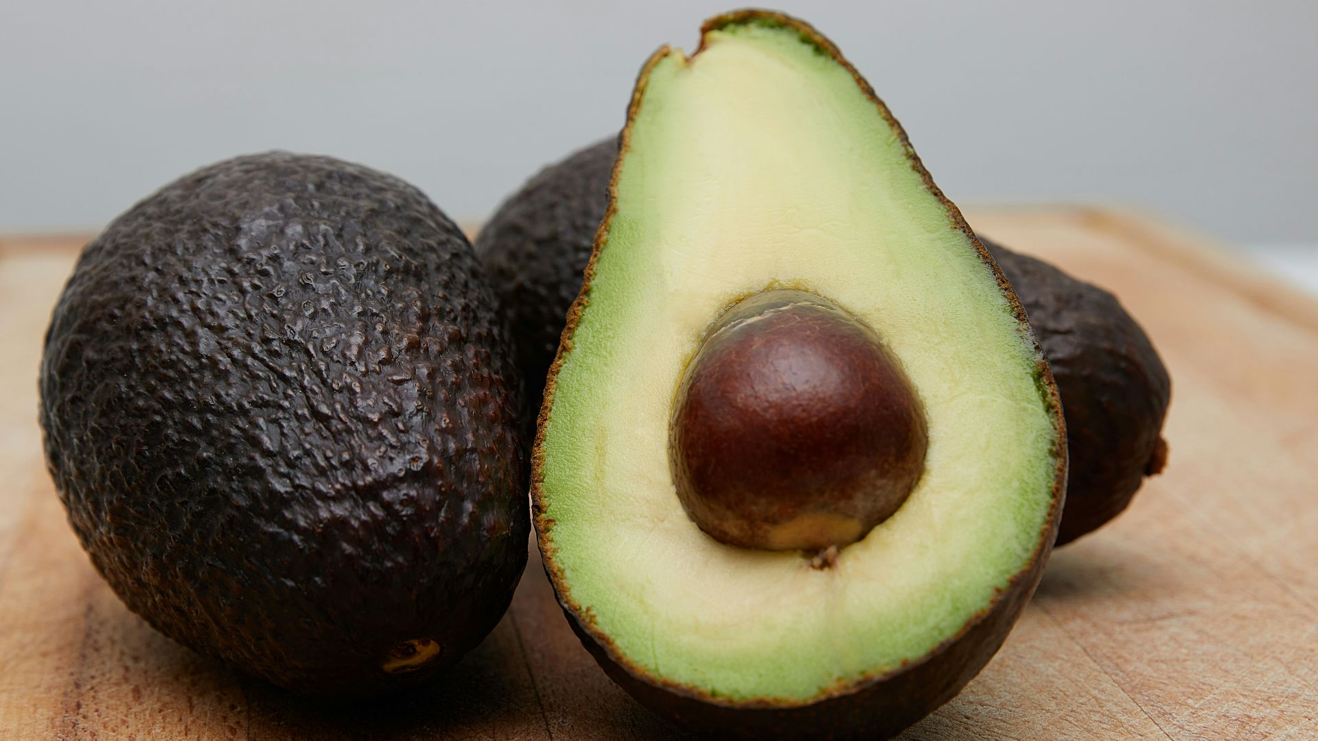 sliced avocado fruit on brown wooden table