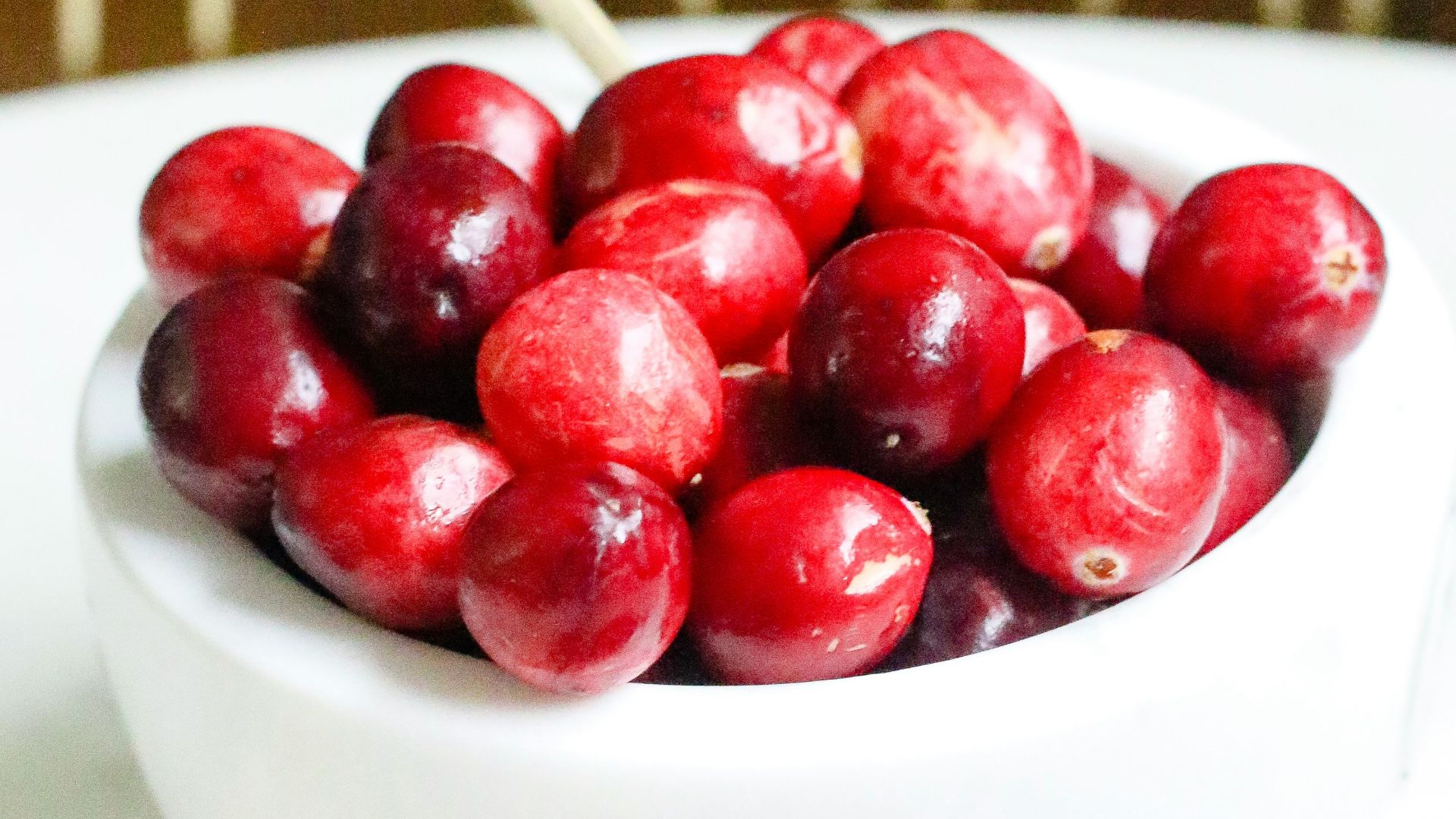 red cherries in white ceramic bowl