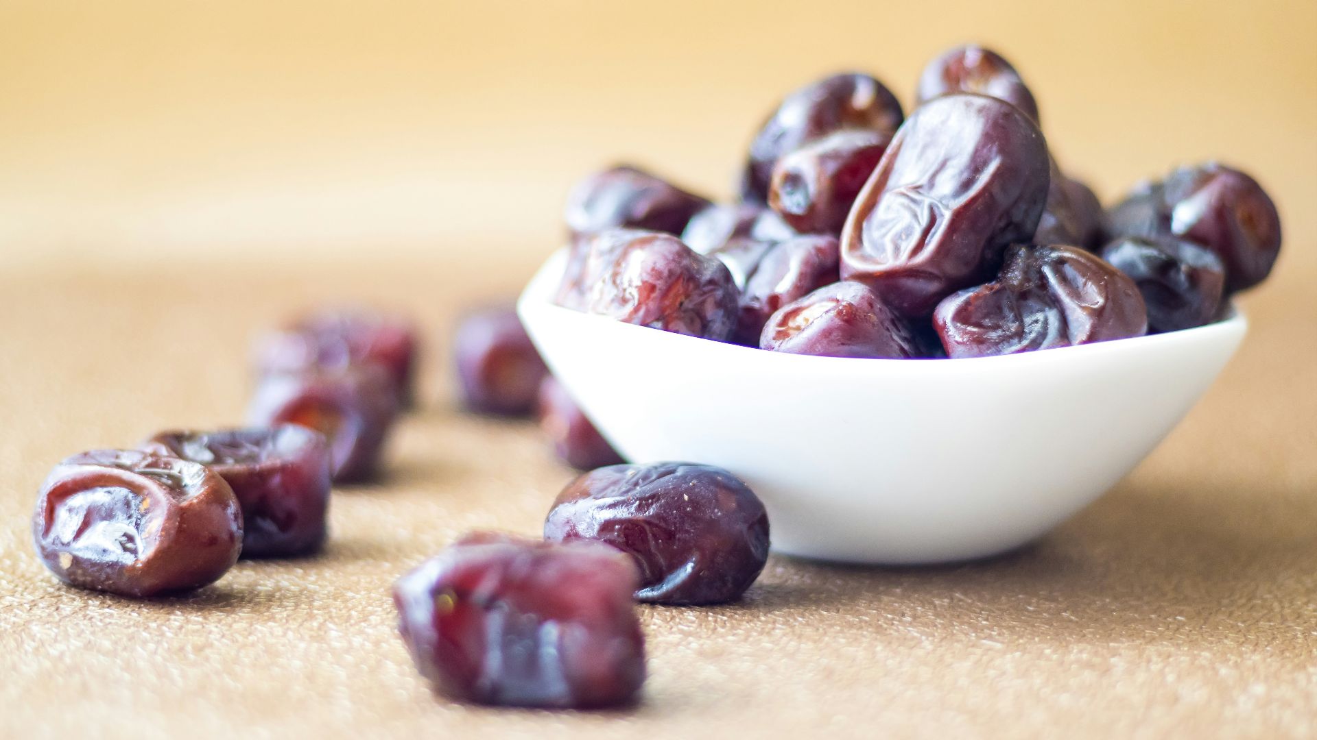 brown round fruit on white ceramic bowl