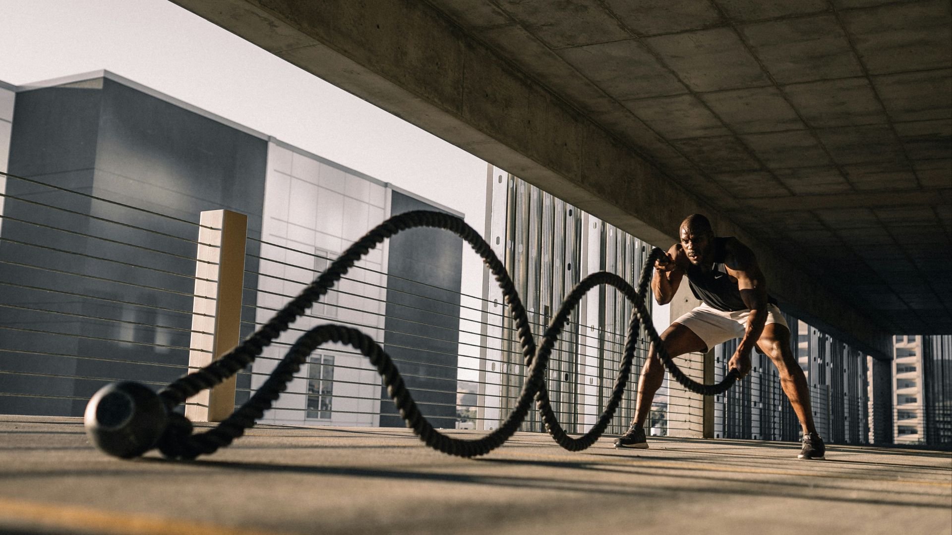 woman in black tank top sitting on brown wooden bench