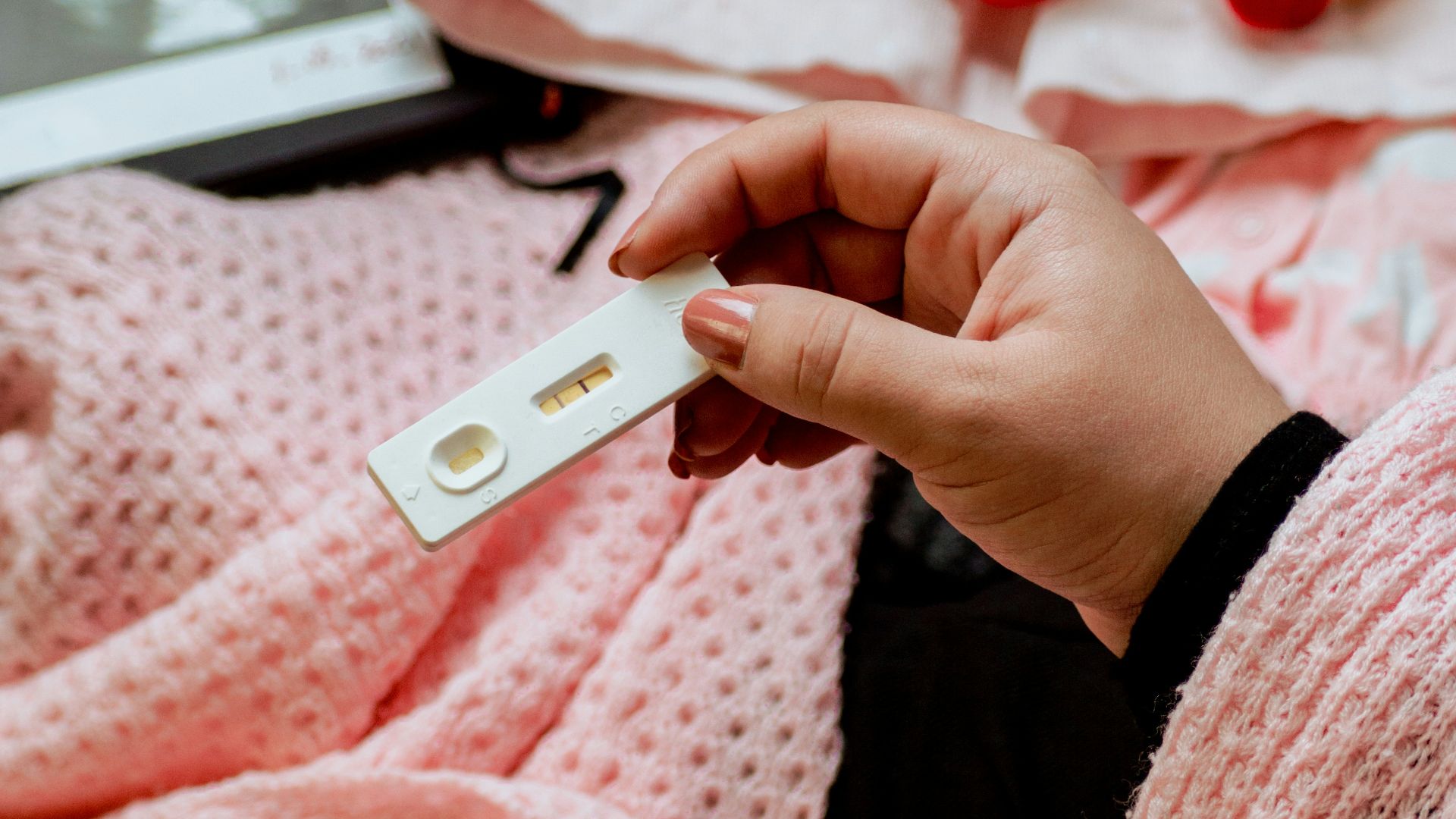 a person holding a baby's name tag in their hand