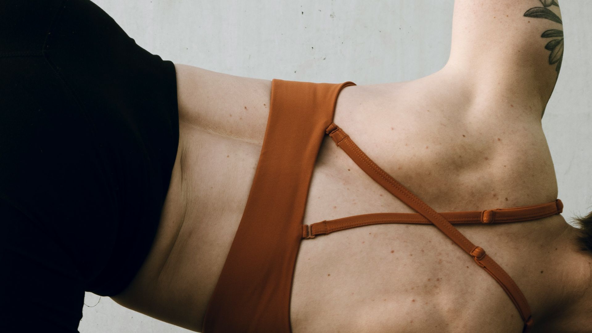 a woman in a brown bikini doing a handstand
