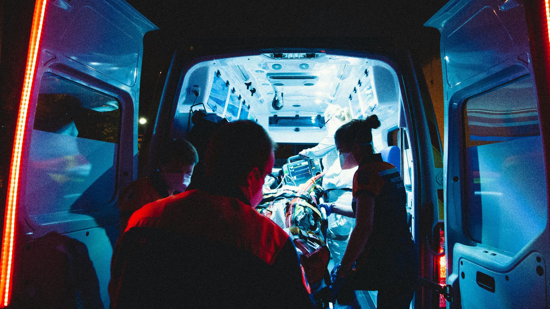 man in red shirt driving car