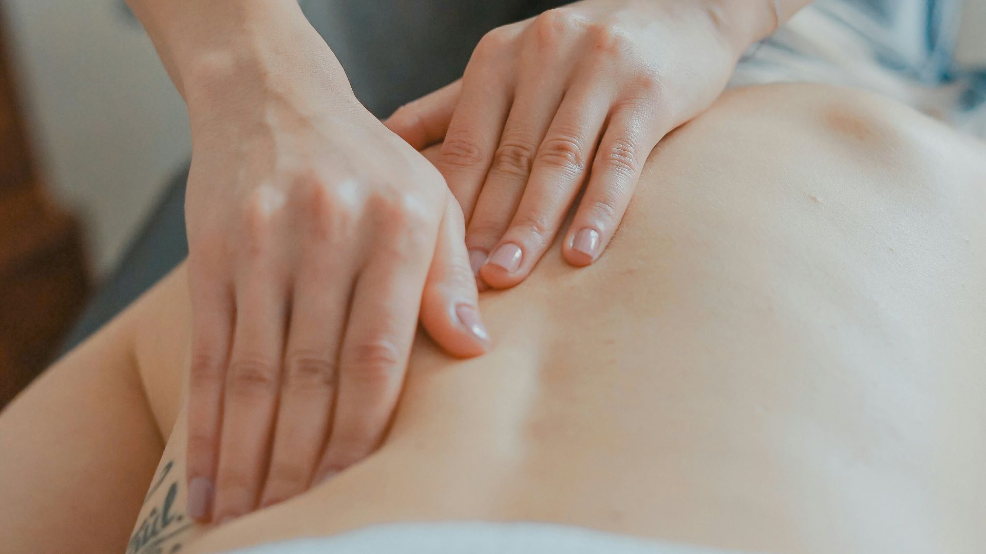 man massaging woman's body