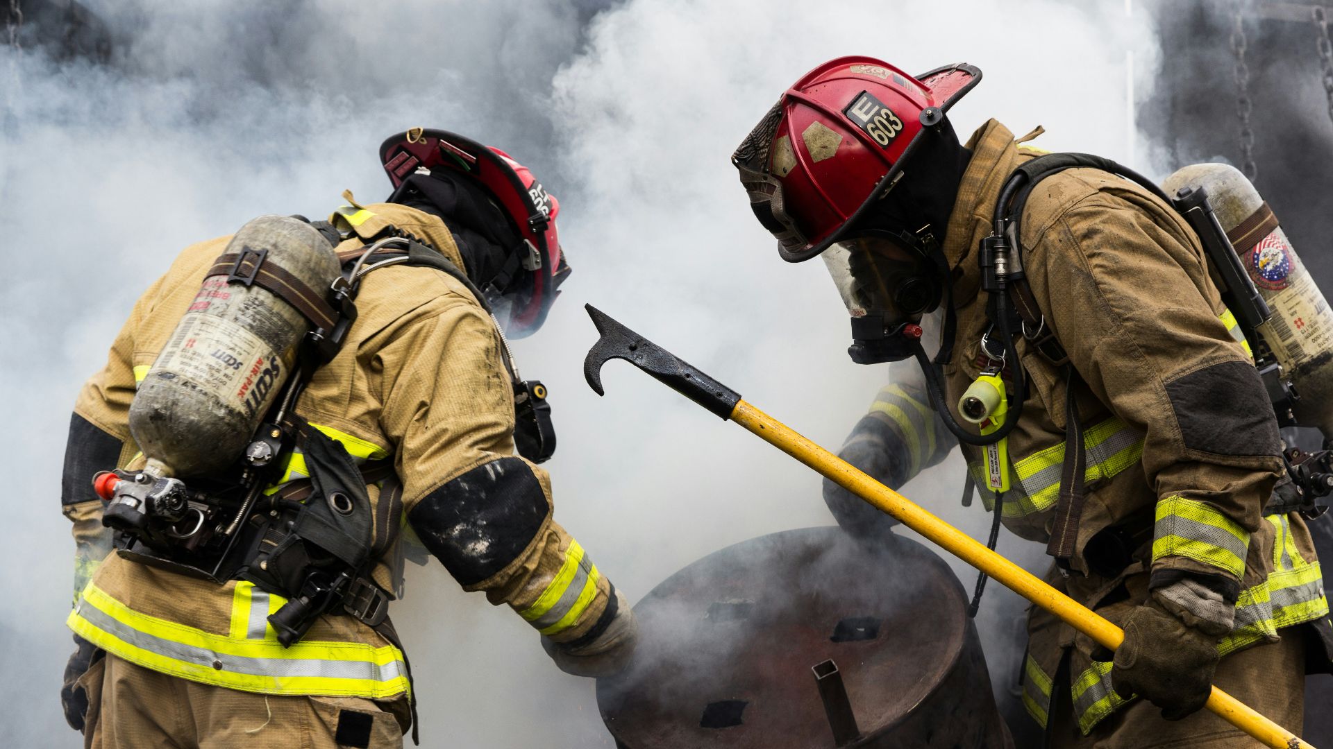two fire men with gas masks