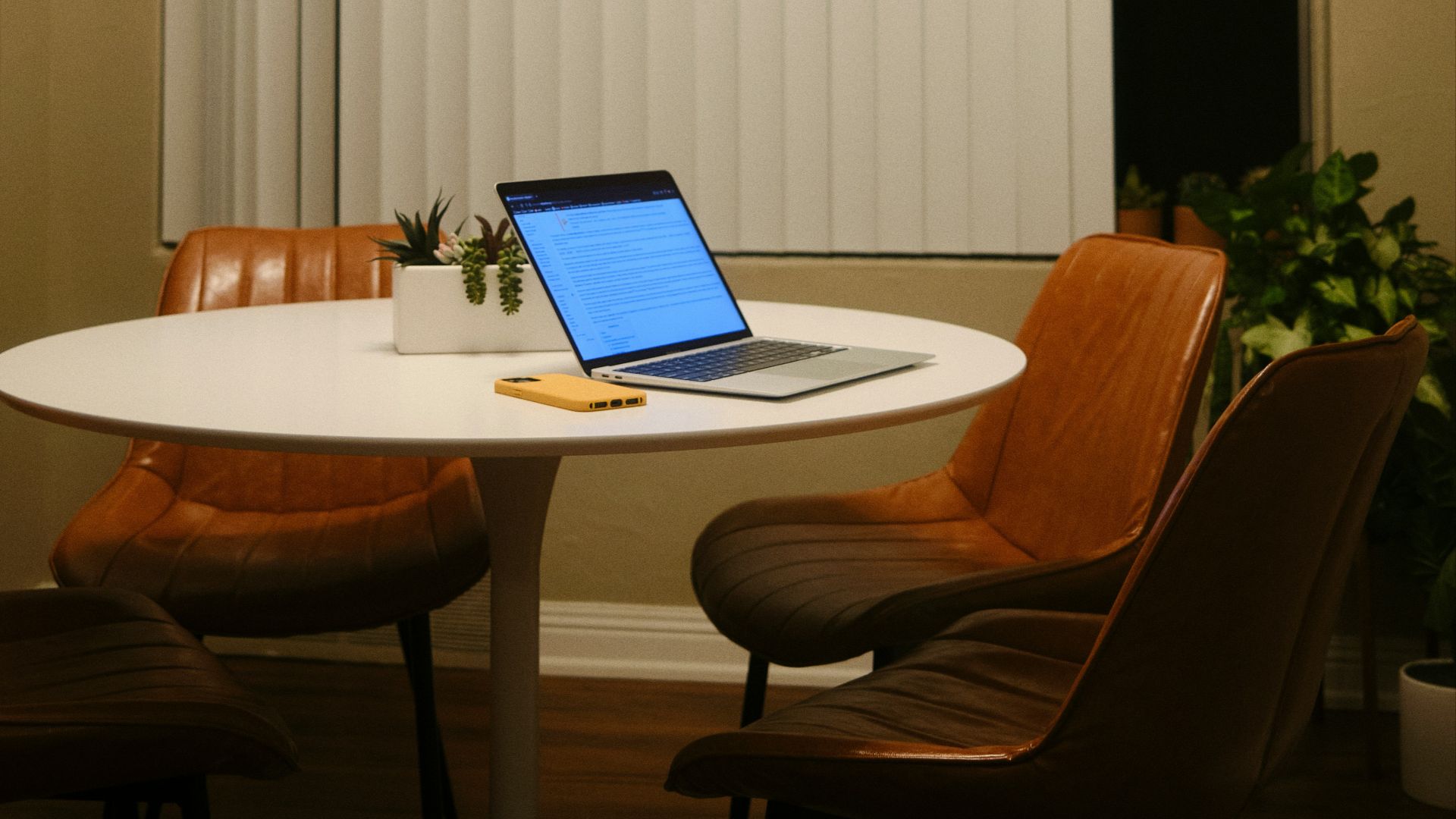 a laptop computer sitting on top of a white table