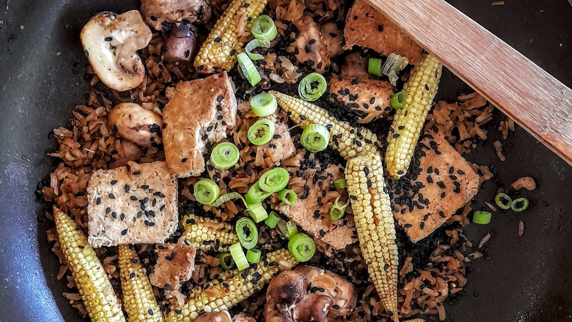 brown wooden ladle on black round plate