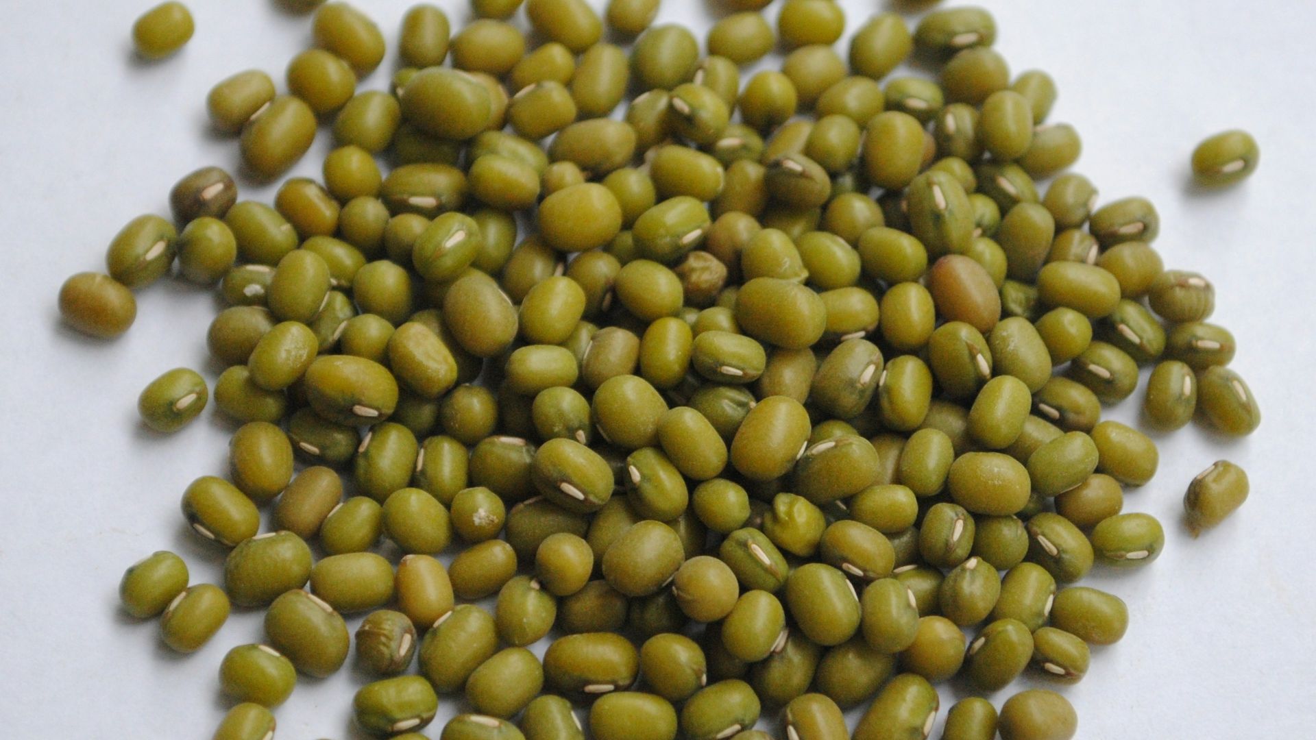 yellow beans on white surface