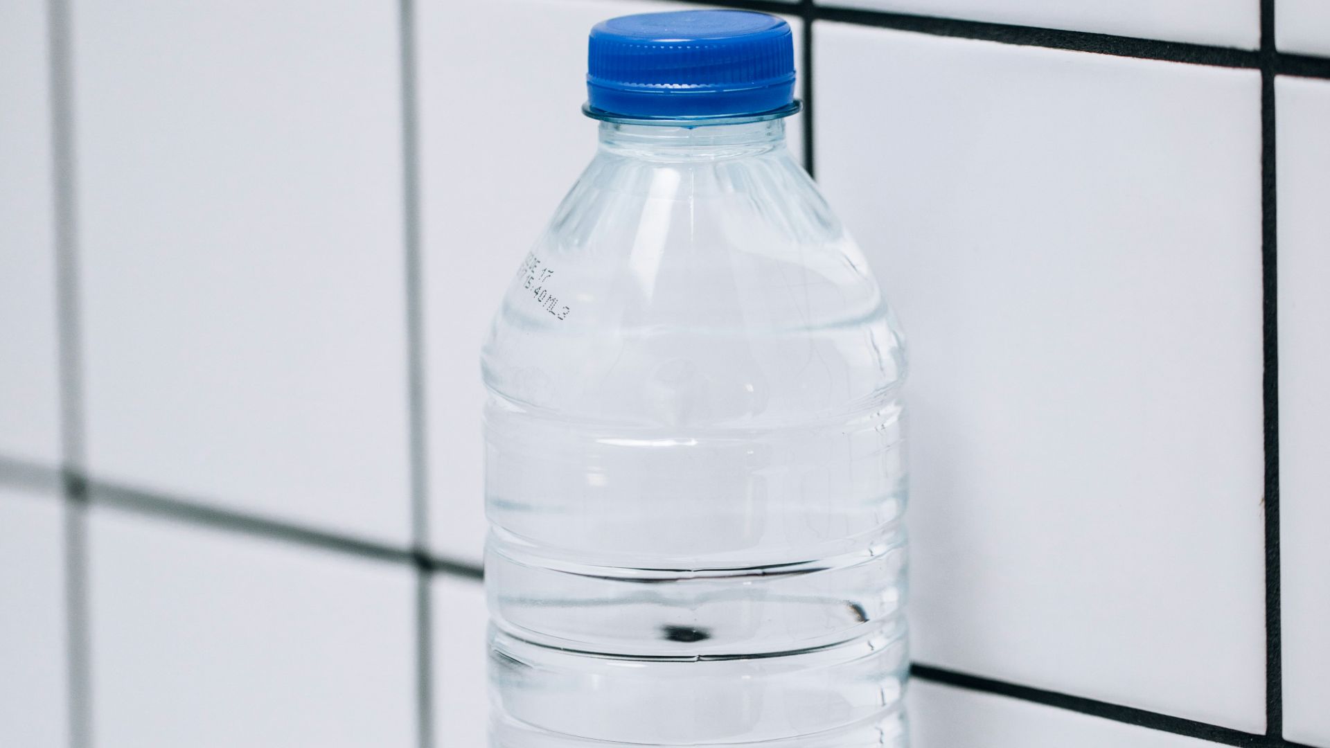clear plastic bottle on white ceramic tiles