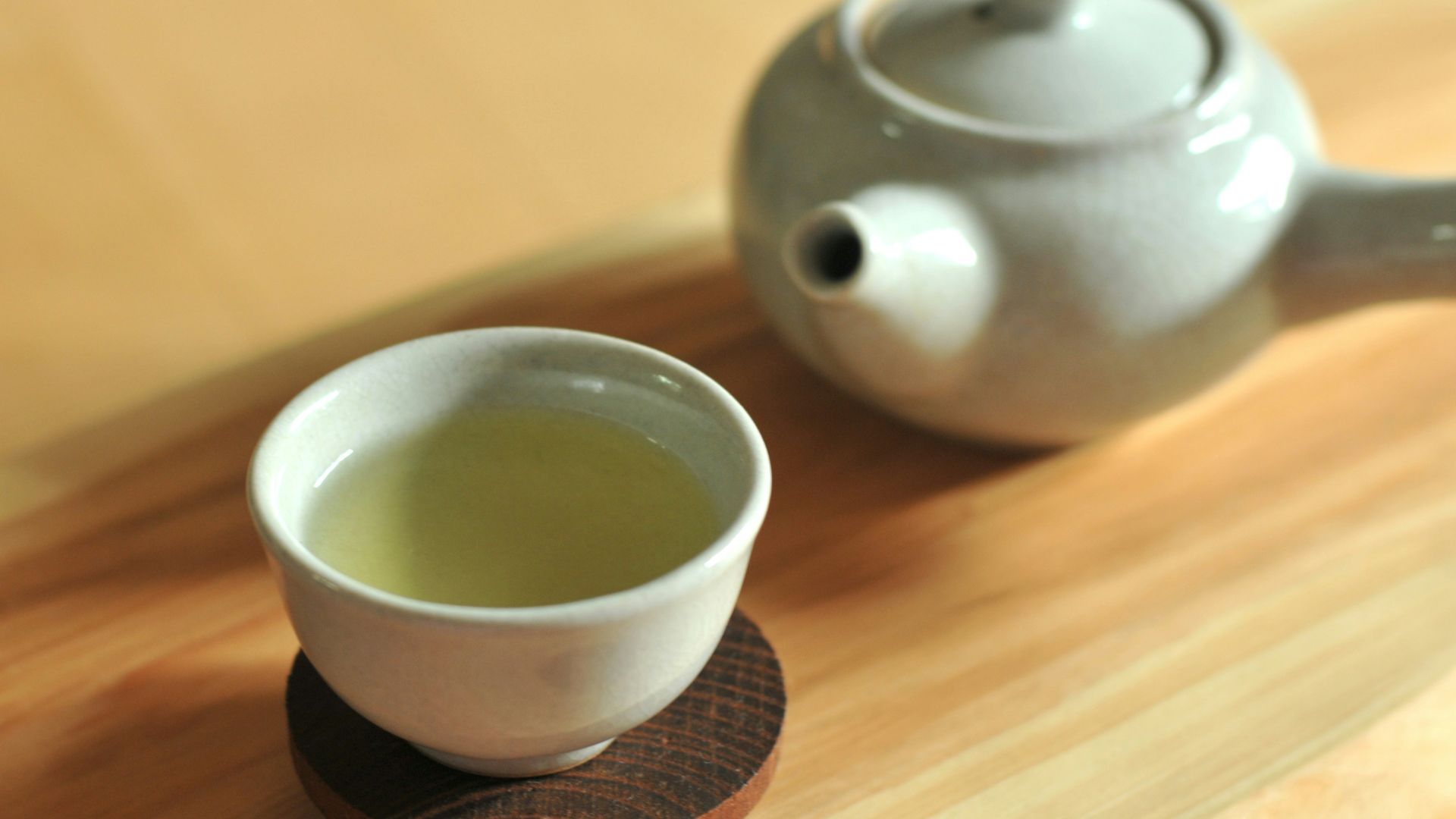white ceramic teacup on brown wooden table