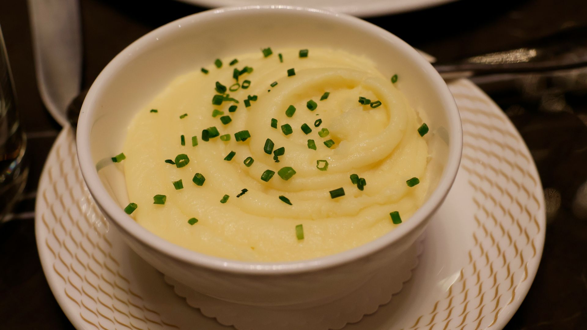 a bowl of mashed potatoes topped with chives
