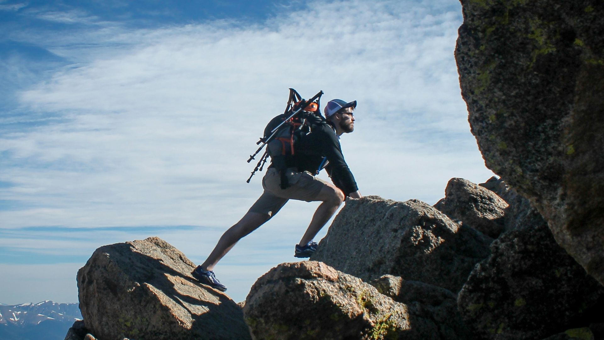 photo of man climbing mountain