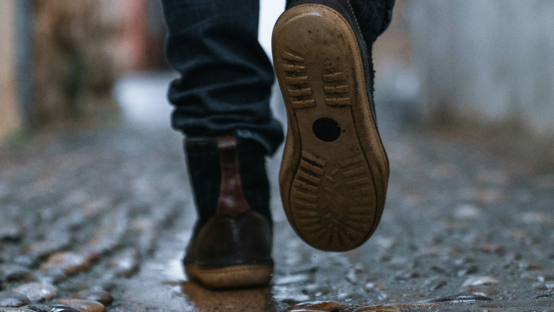 close-up photography of person walking on pavement