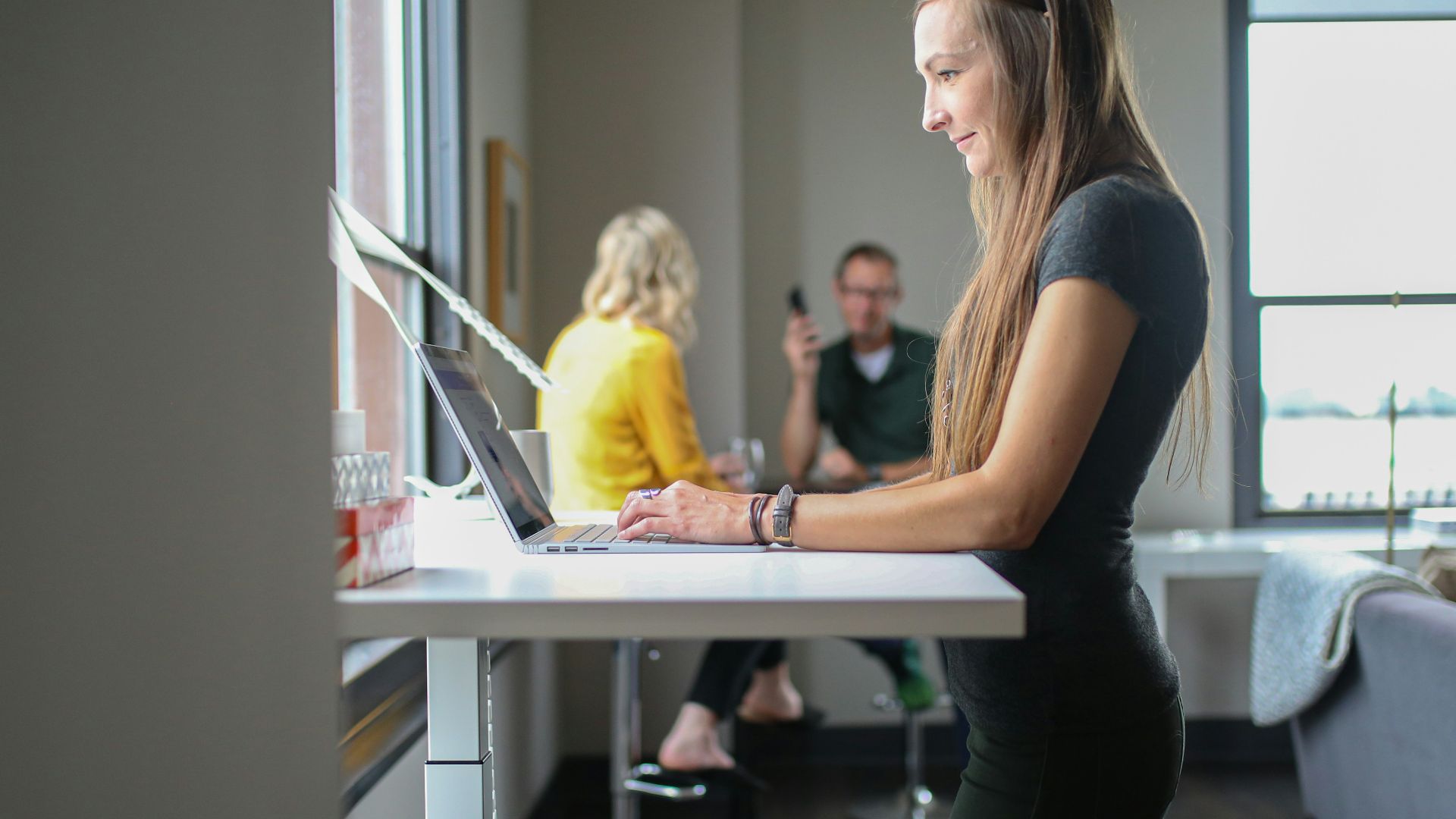 woman in black tank top and black pants sitting on chair