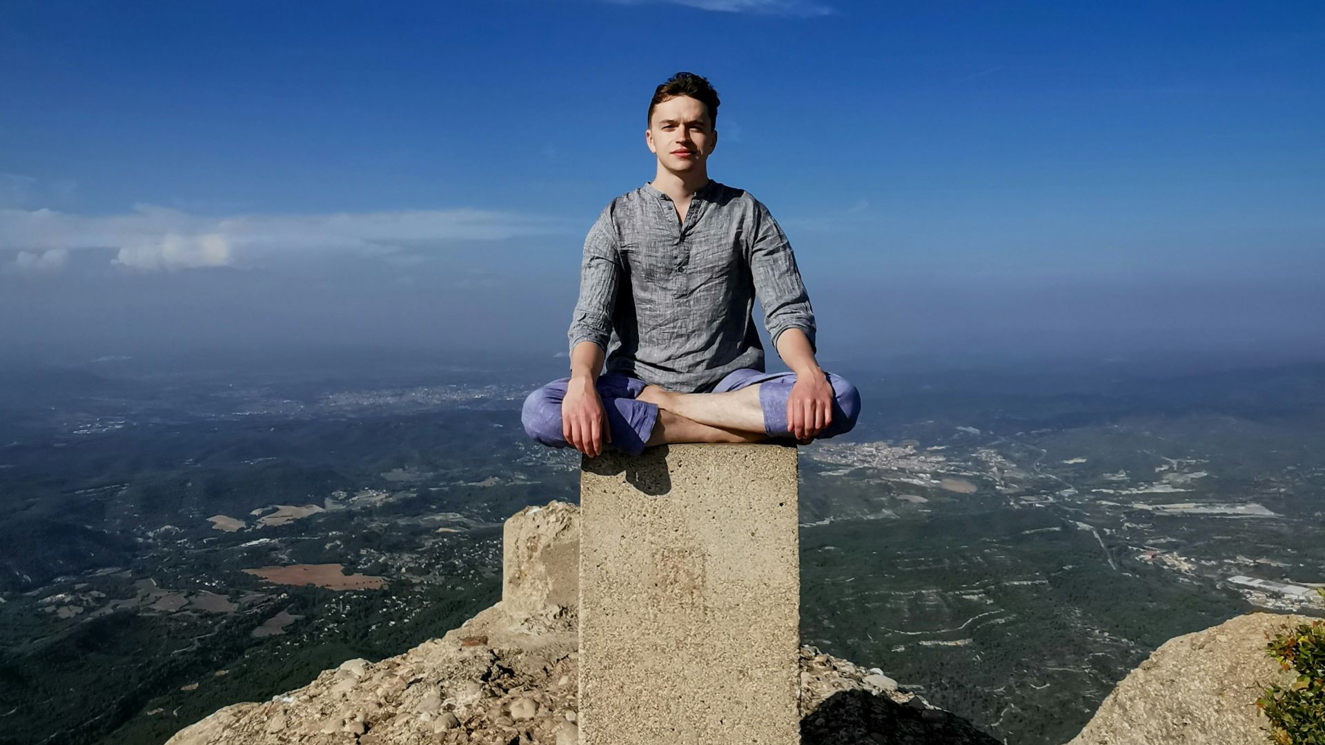 man sitting on column