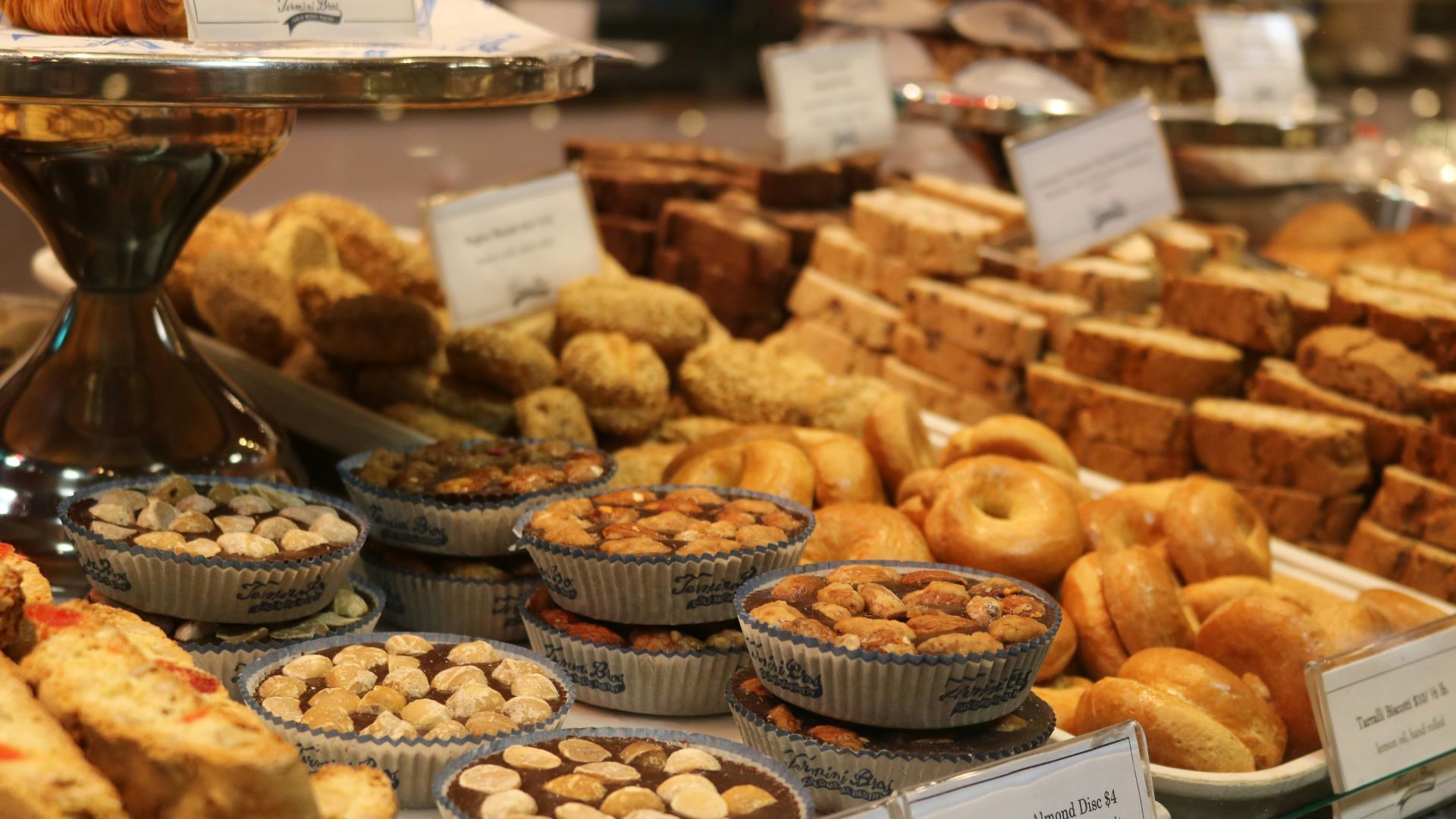 brown and white doughnuts on white wooden rack