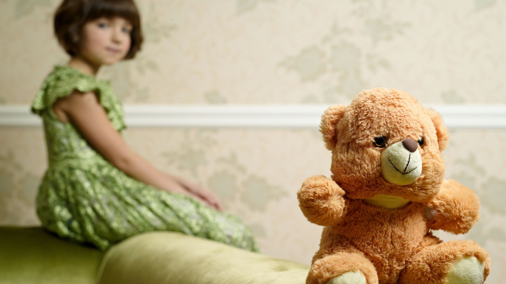 selective focus photography of brown bear plush toy on sofa