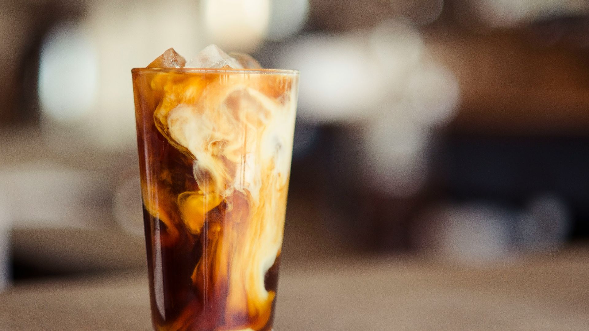 glass cup filled with ice latte on tabletop