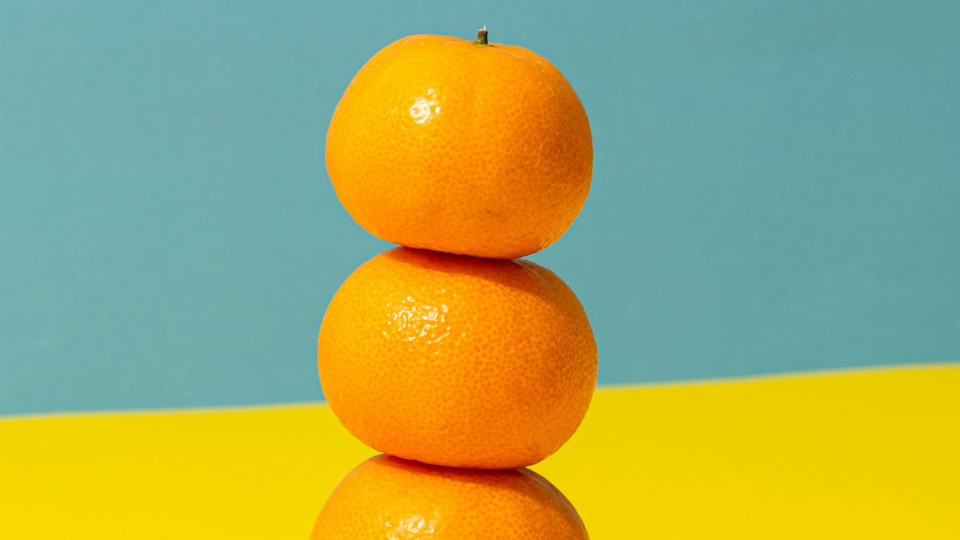 orange fruit on yellow surface