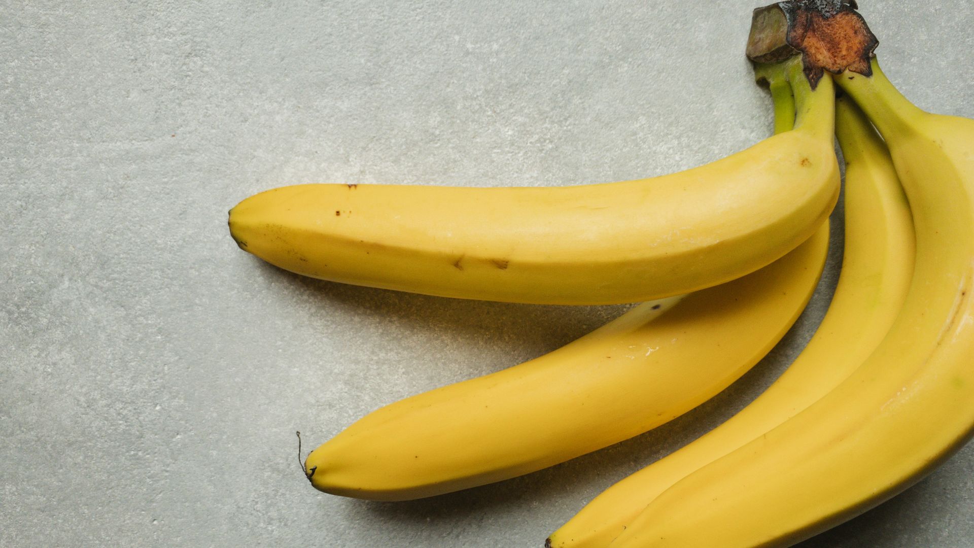 yellow banana fruit on gray table