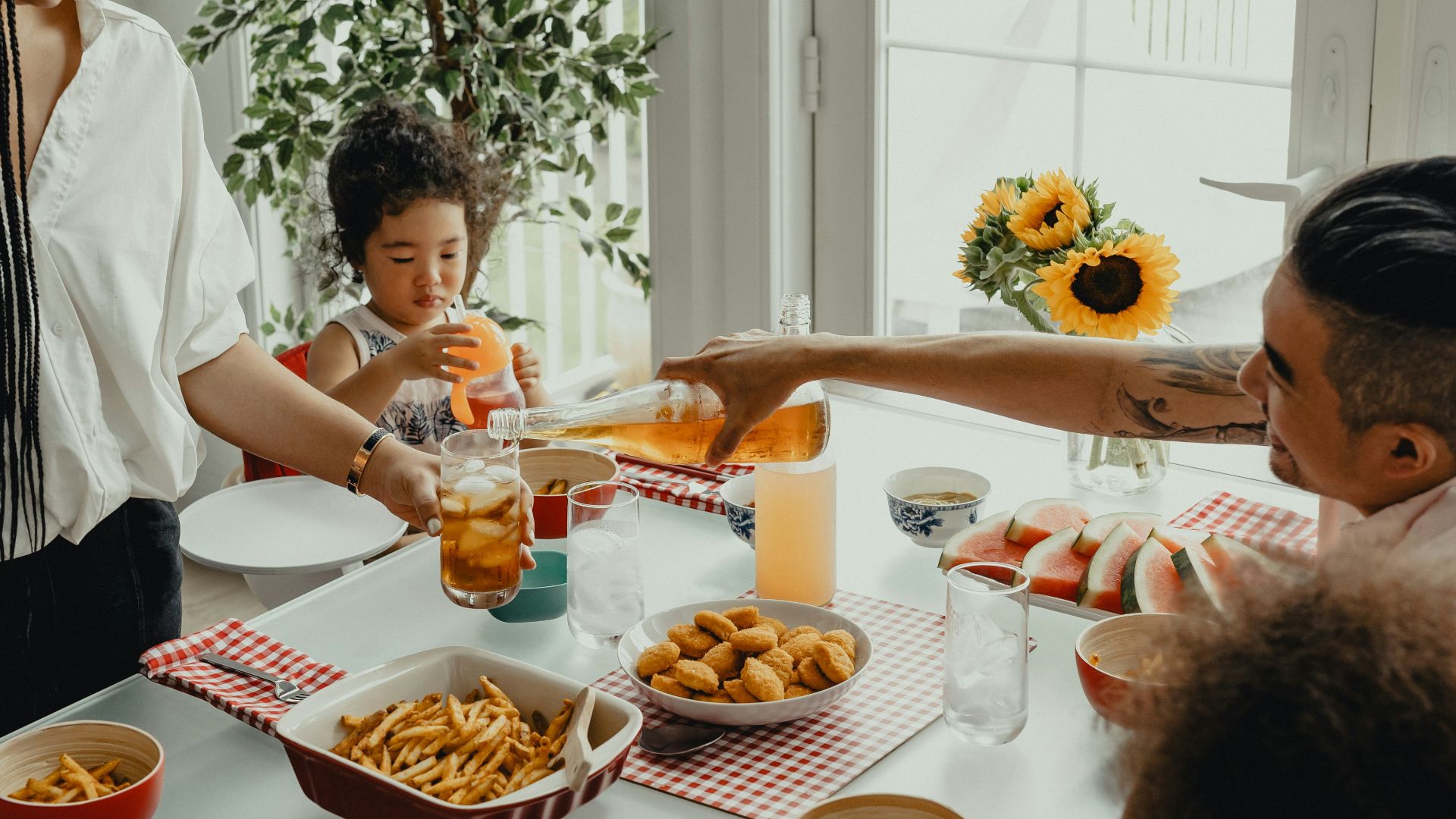 woman in white shirt holding a girl in white shirt